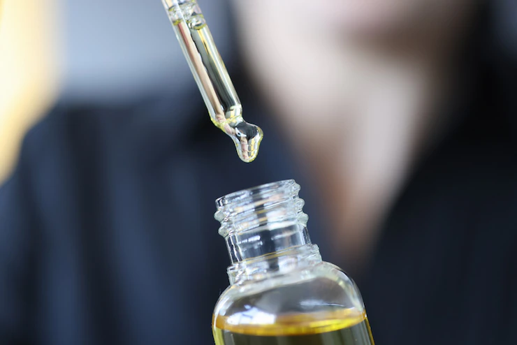 CBD oil is being suck from the CBD oil bottle using dropper