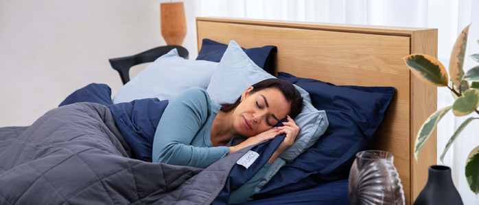 An image showing a person sleeping comfortably in bed, indicating the importance of how much deep sleep do you need for a healthy lifestyle.