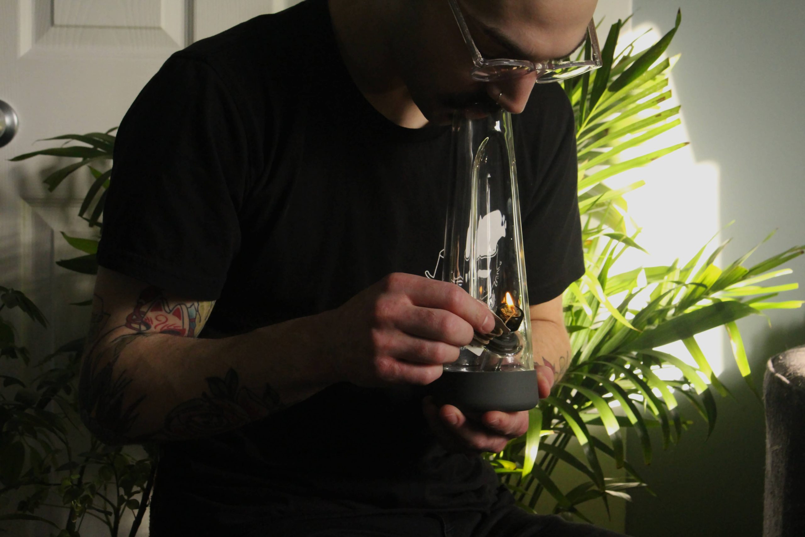 A person smoking hash from a bong